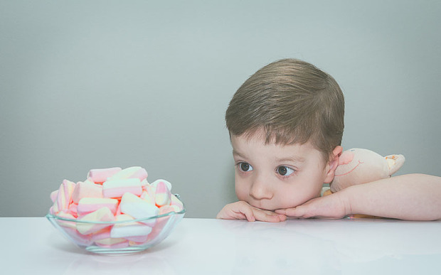 Boy hugging toy, looking at bowl of marshmallows getty creative easy access